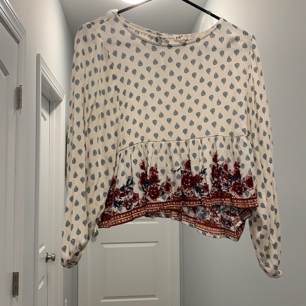 Cream white top with flare at the bottom